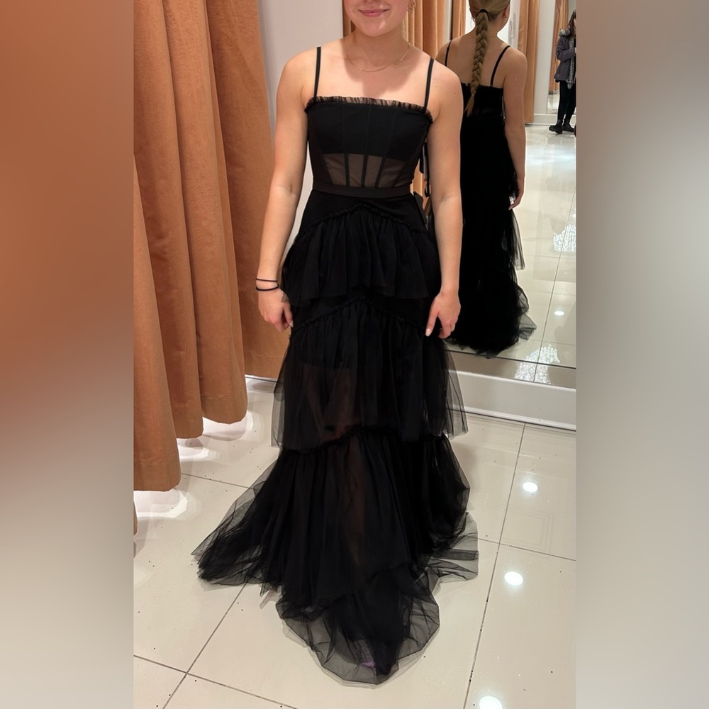 Ruffled black prom dress: layered mesh, corset, spaghetti straps.
